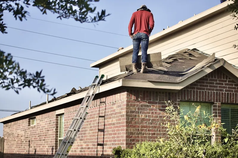 Professional roofer working on a residential roof in Goodnight Ranch